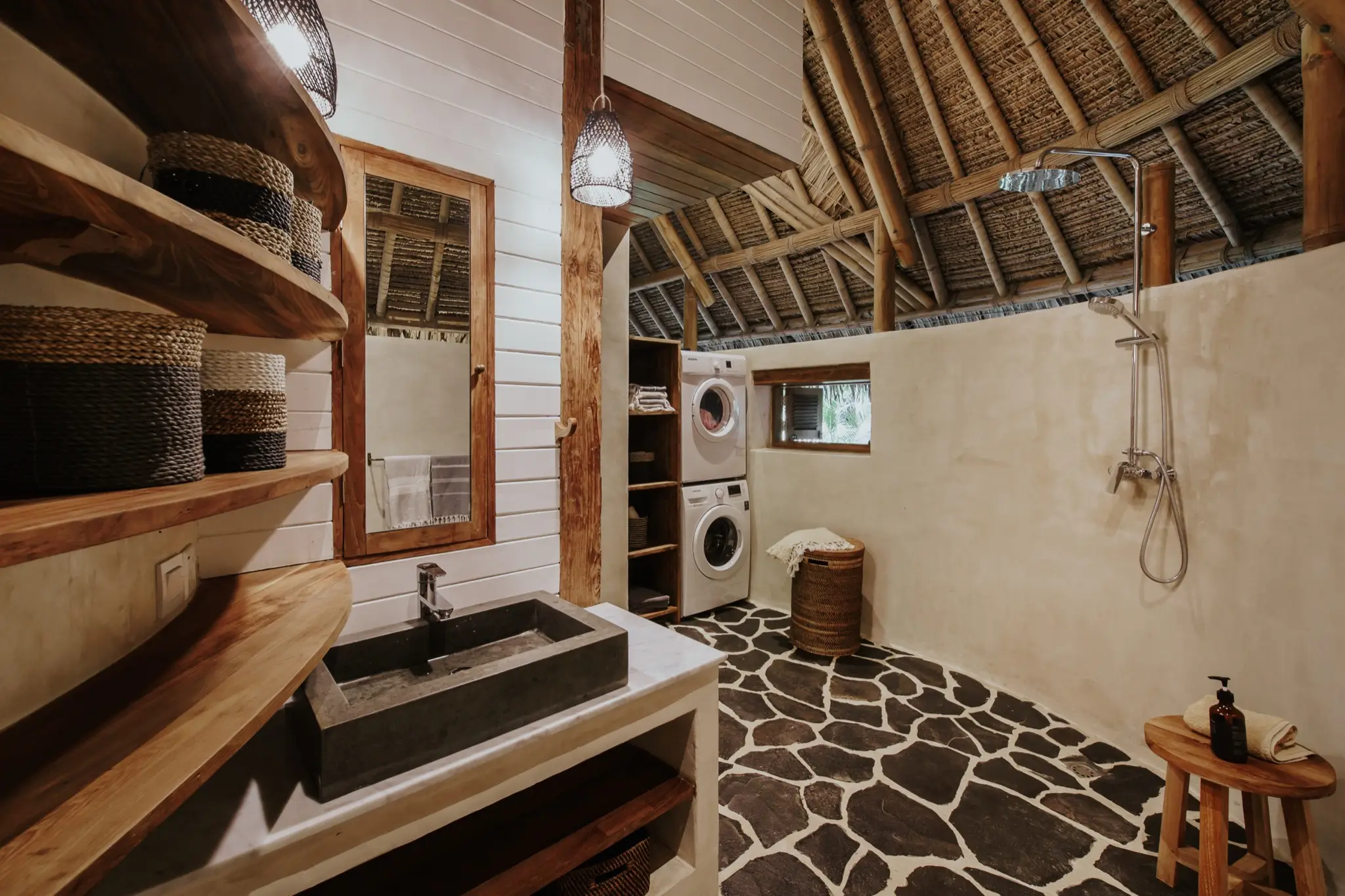 Bathroom with carved stone basin and rain shower