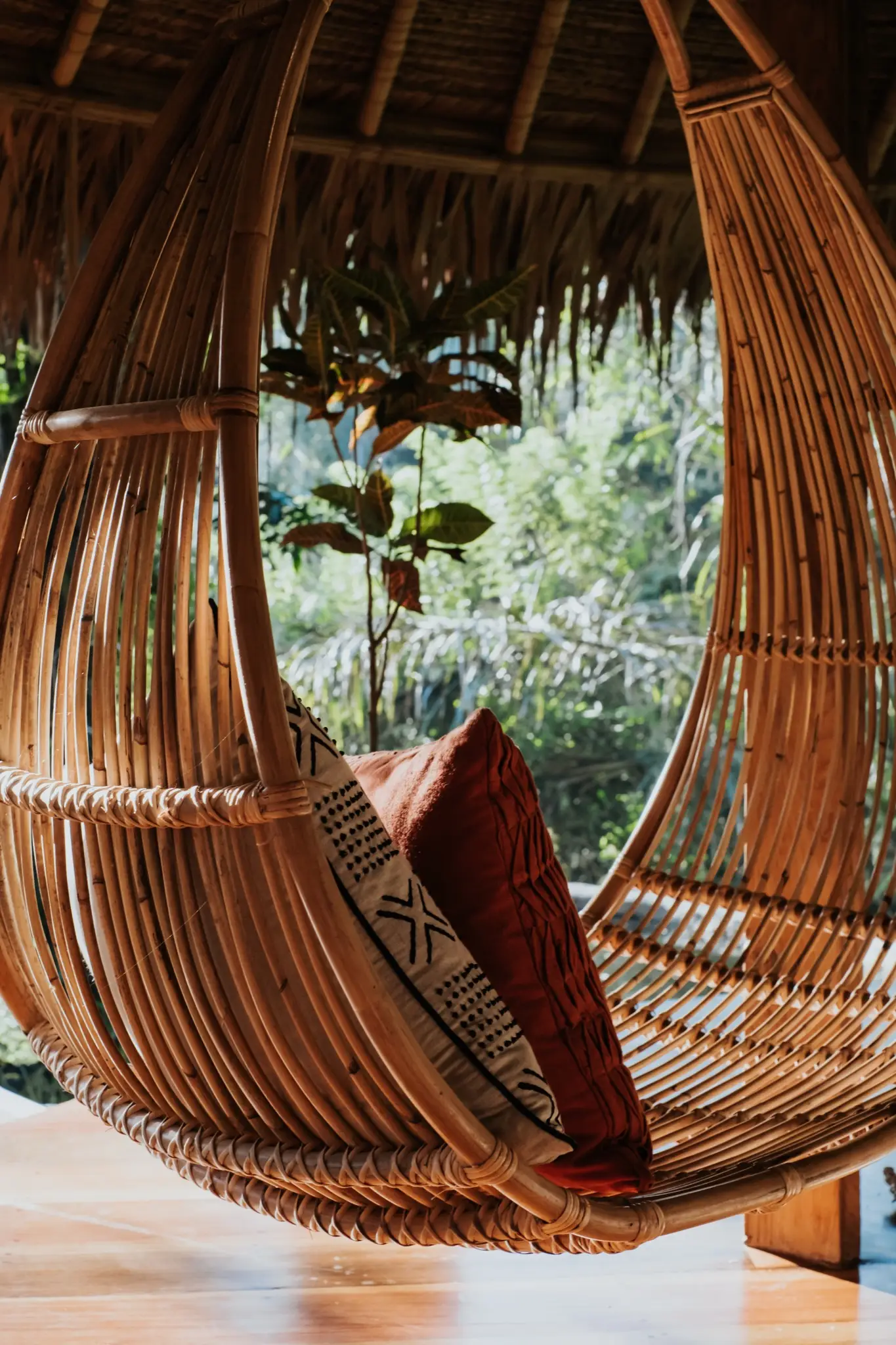 Woven rattan hanging chair by the window