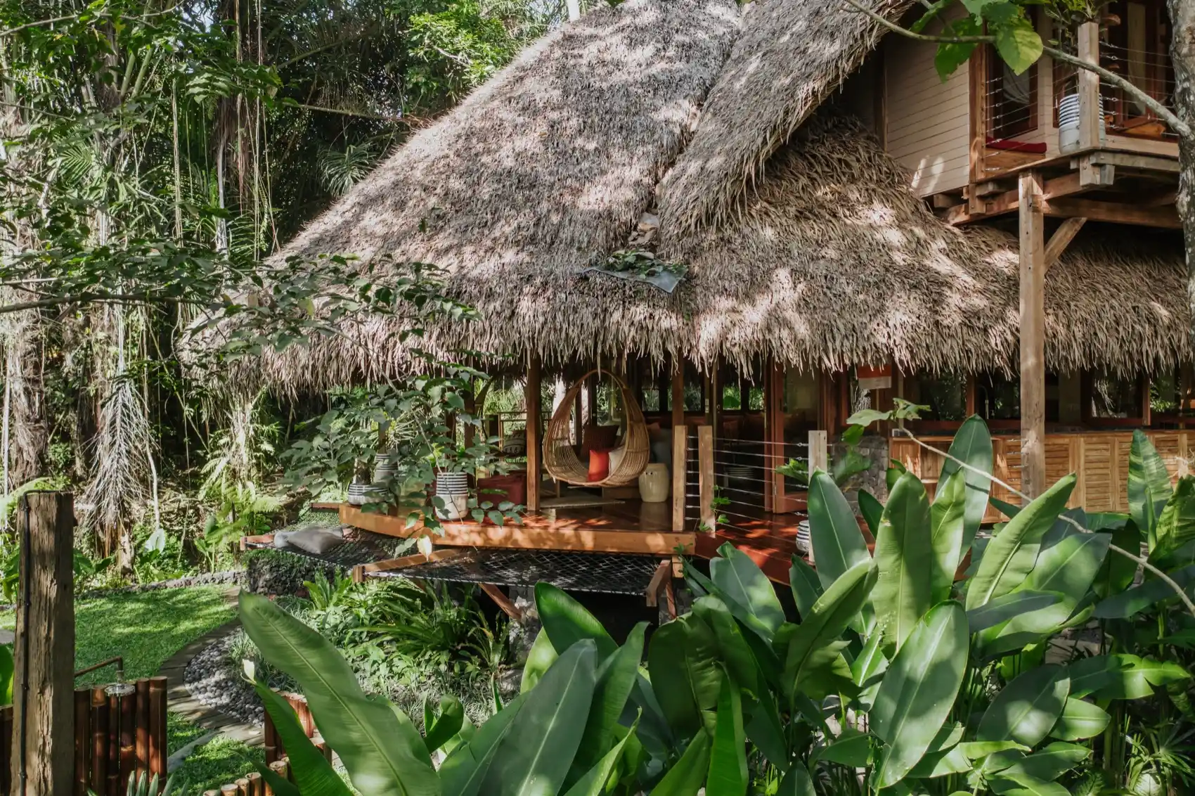 Thatched villa surrounded by jungle